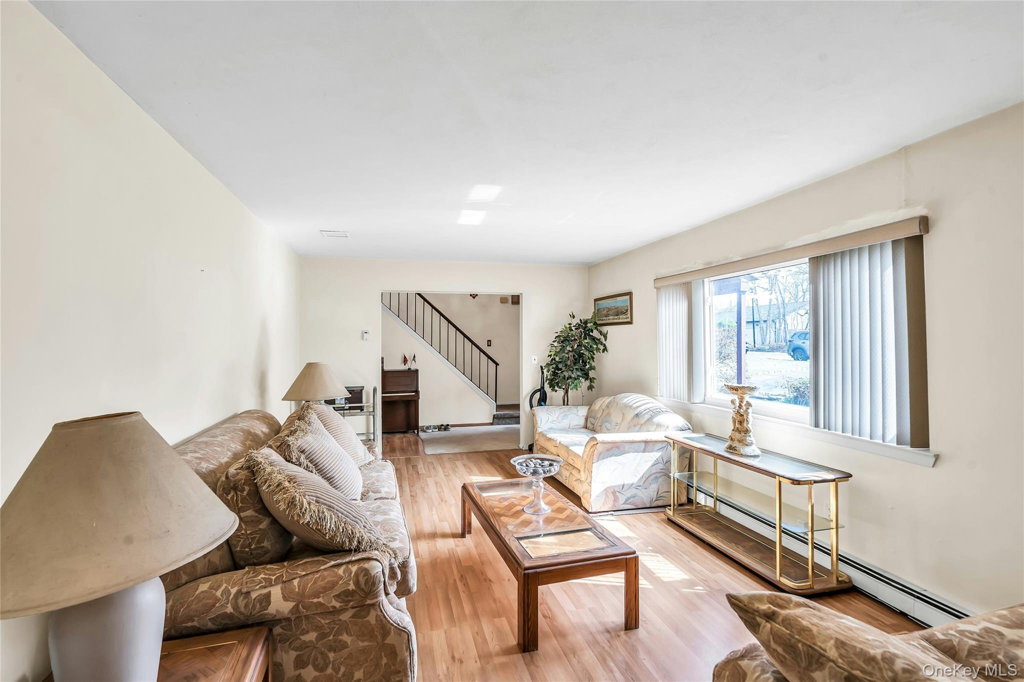 7 Hastings Drive Ridge, NY 11961 - Photo 5 of 33 a living room with furniture and a window