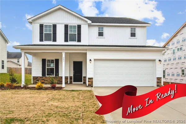 a view of a white house with large windows