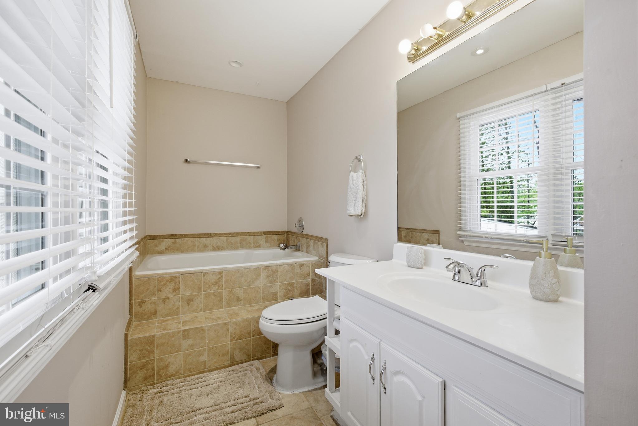 8664 Pohick Forest Court Springfield, VA 22153 - Photo 27 of 41 a bathroom with a sink a toilet and shower