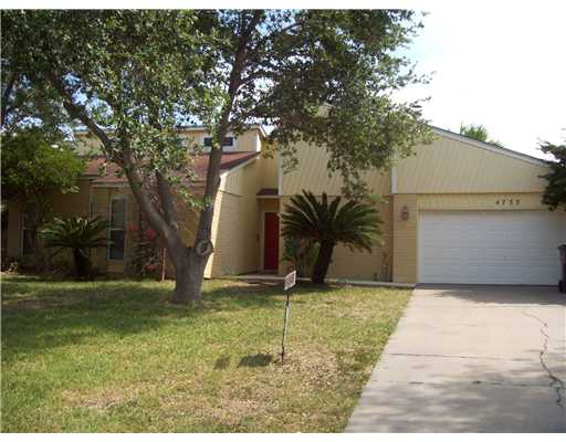 a house that has a tree in front of it