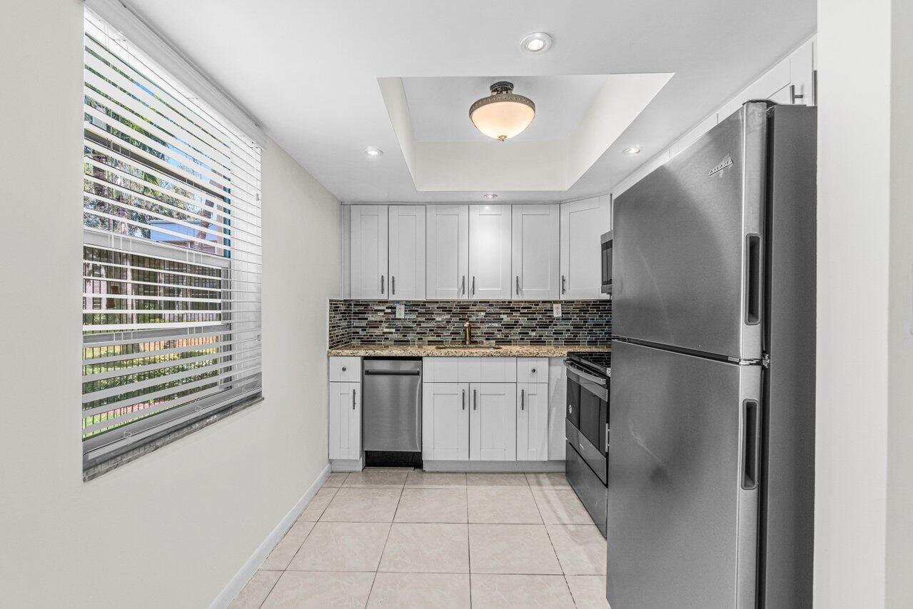 a kitchen with a refrigerator and a sink