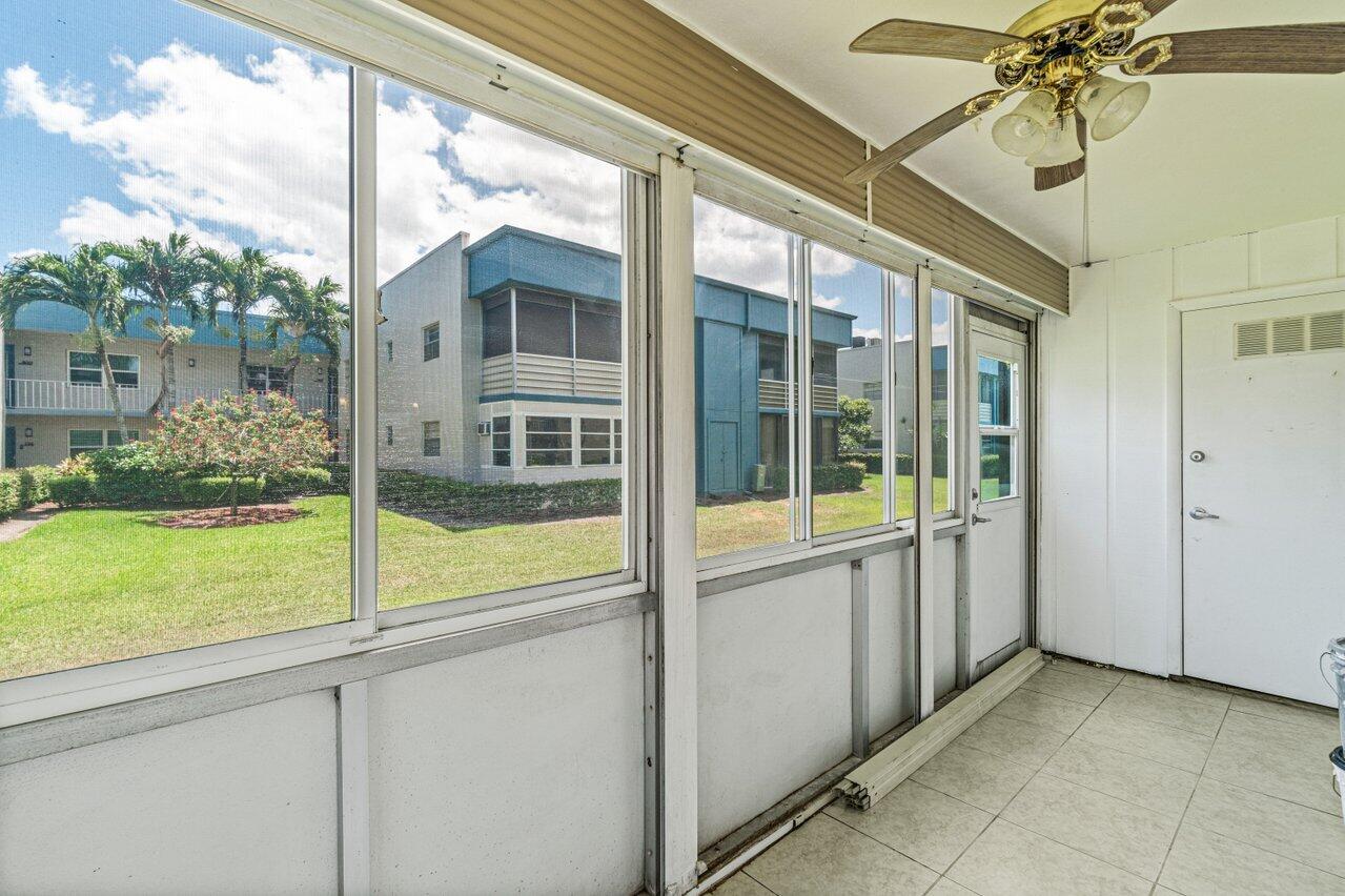 641 Normandy Lane, Unit N Delray Beach, FL 33484 - Photo 19 of 26 a view of a porch and a yard
