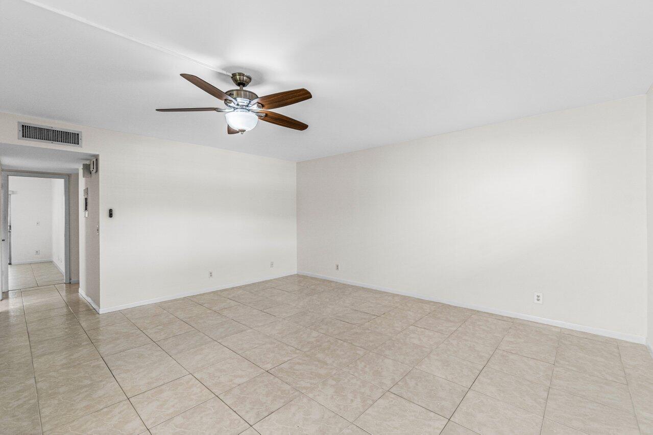 641 Normandy Lane, Unit N Delray Beach, FL 33484 - Photo 8 of 26 an empty room with closet and fan