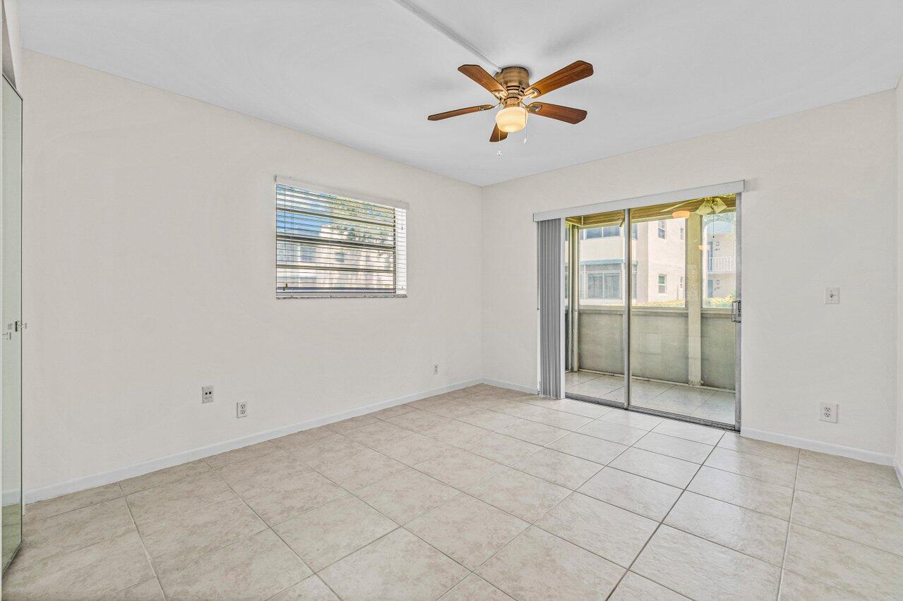 641 Normandy Lane, Unit N Delray Beach, FL 33484 - Photo 10 of 26 an empty room with windows and fan