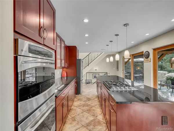 a kitchen with stainless steel appliances granite countertop a stove and a refrigerator
