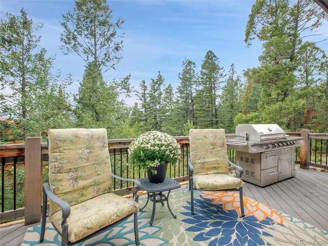 a view of a dinning table and chairs in the roof deck