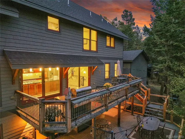 a backyard of a house with barbeque oven and furniture
