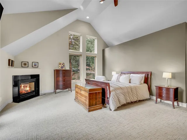a spacious bedroom with a bed and a fireplace