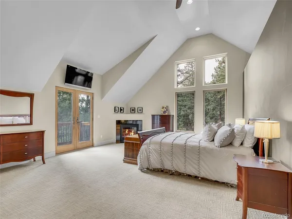 a spacious bedroom with a bed and large windows