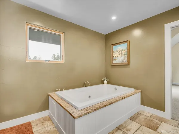 a bathroom with a tub and a window