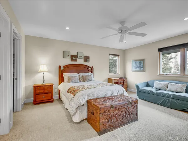 a bedroom with a bed couch and window
