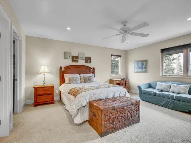 a bedroom with a bed couch and window