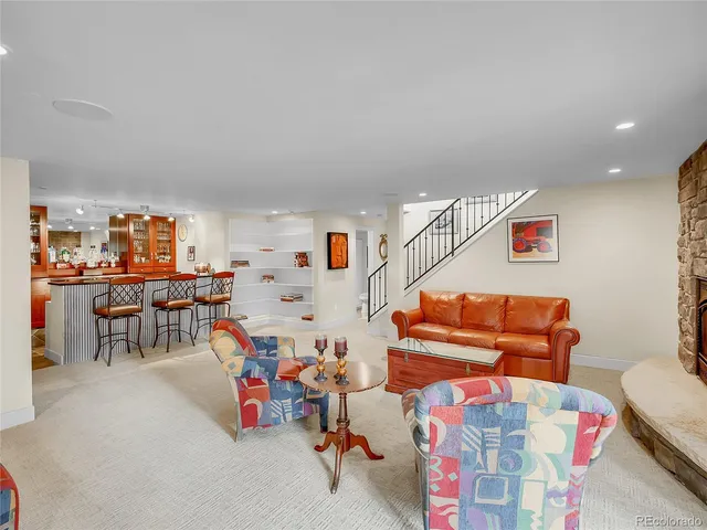 a living room with furniture and a kitchen view