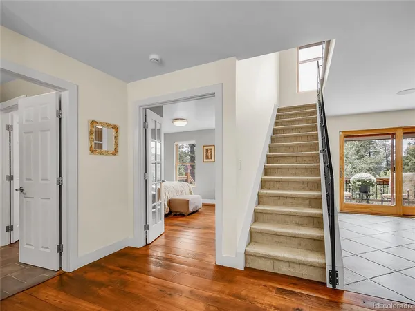 a view of a hallway with wooden floor and entryway