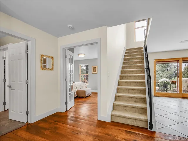a view of a hallway with wooden floor and entryway