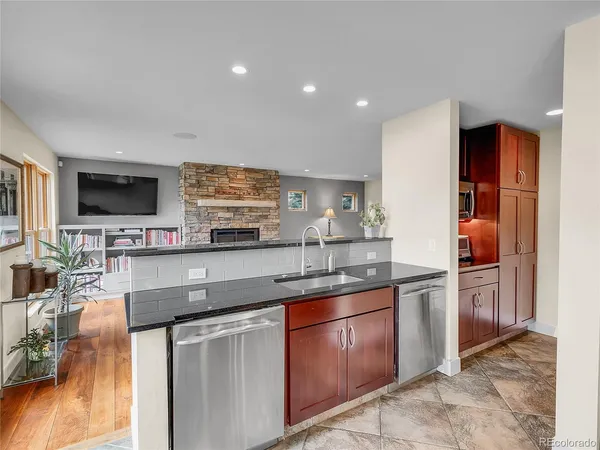 a kitchen with stainless steel appliances granite countertop a sink and a stove