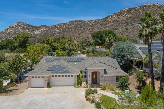 an aerial view of a house with a yard