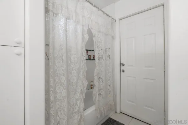 a bedroom with a bed a couch and a window
