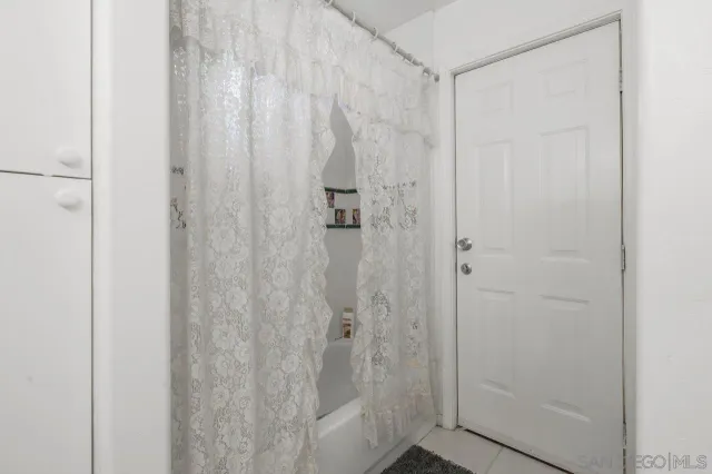 a bedroom with a bed a couch and a window