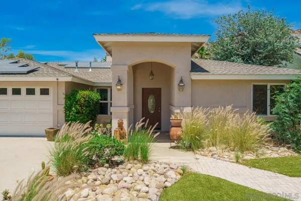 a living room with furniture a flat screen tv and a large window