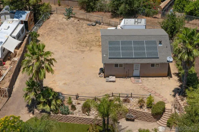an aerial view of a houses with outdoor space
