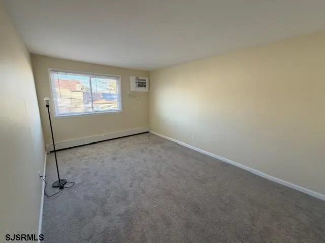 an empty room with a empty space and windows