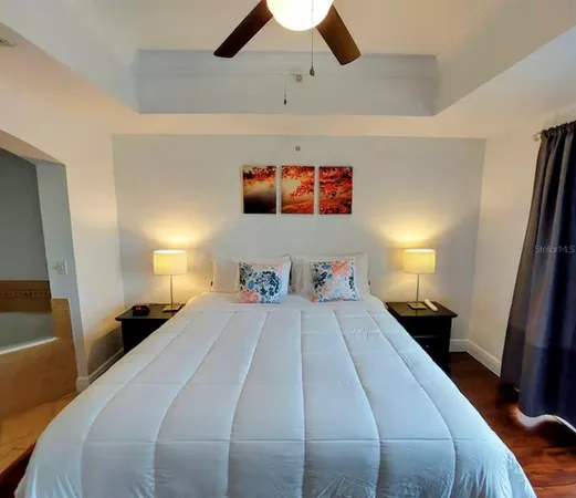 a bedroom with a bed and a large mirror