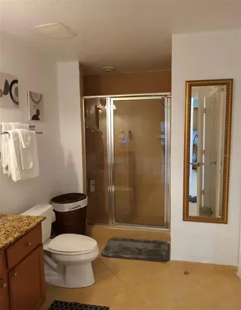 a bathroom with a toilet sink and shower