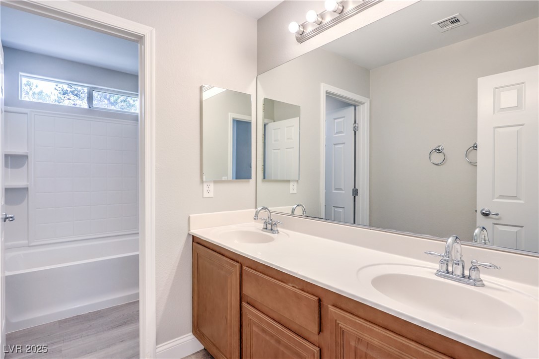 585 Foster Springs Road Las Vegas, NV 89148 - Photo 31 of 39 Full bathroom with double vanity, wood finished floors, and bathing tub / shower combination