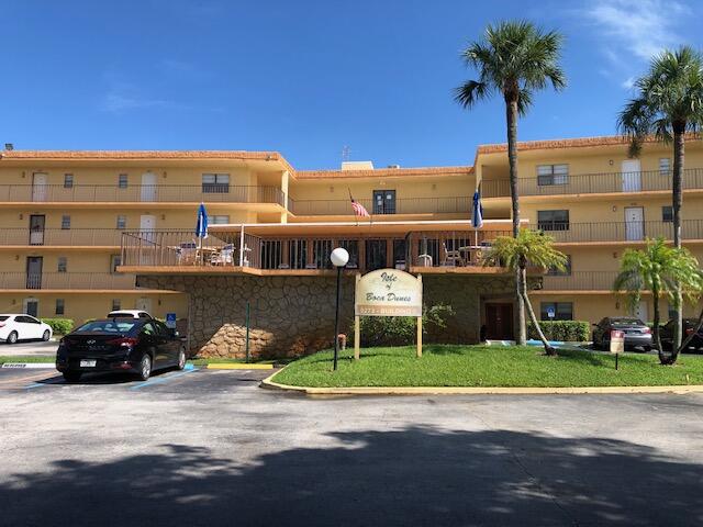 9273 Southwest 8th Street, Unit 417 Boca Raton, FL 33428 - Photo 1 of 25 a view of parked cars in front of building