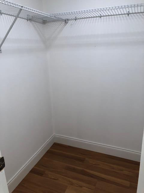 9273 Southwest 8th Street, Unit 417 Boca Raton, FL 33428 - Photo 15 of 25 a view of a room with wooden floor and fan