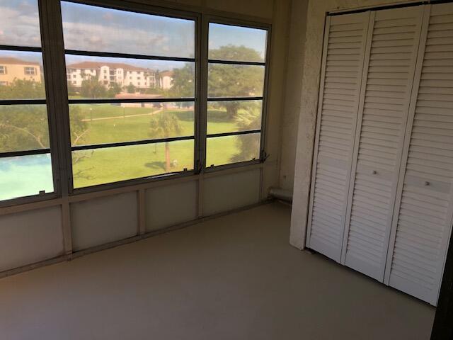 9273 Southwest 8th Street, Unit 417 Boca Raton, FL 33428 - Photo 20 of 25 a view of an empty room with a window