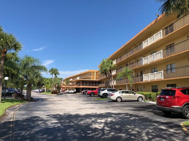 9273 Southwest 8th Street, Unit 417 Boca Raton, FL 33428 - Photo 2 of 25 a car parked in front of a building