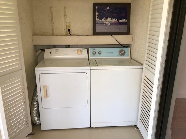 9273 Southwest 8th Street, Unit 417 Boca Raton, FL 33428 - Photo 22 of 25 a utility room with dryer and washer