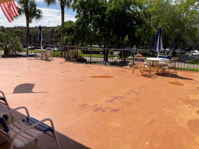 a view of backyard with swimming pool and furniture