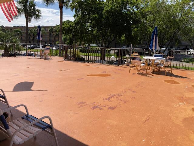 9273 Southwest 8th Street, Unit 417 Boca Raton, FL 33428 - Photo 25 of 25 a view of backyard with swimming pool and furniture