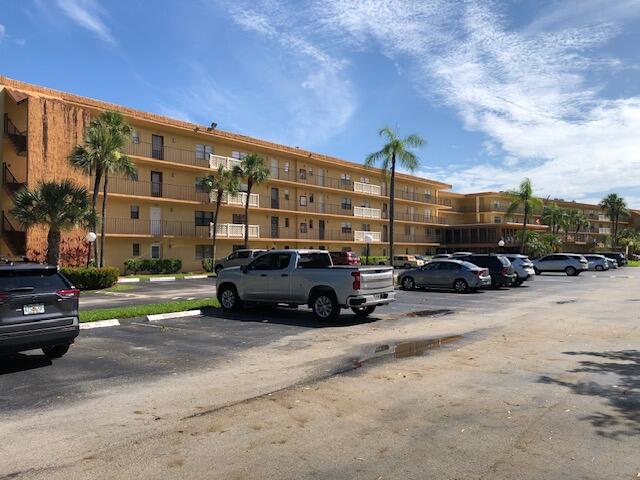 9273 Southwest 8th Street, Unit 417 Boca Raton, FL 33428 - Photo 3 of 25 a view of street with parked cars