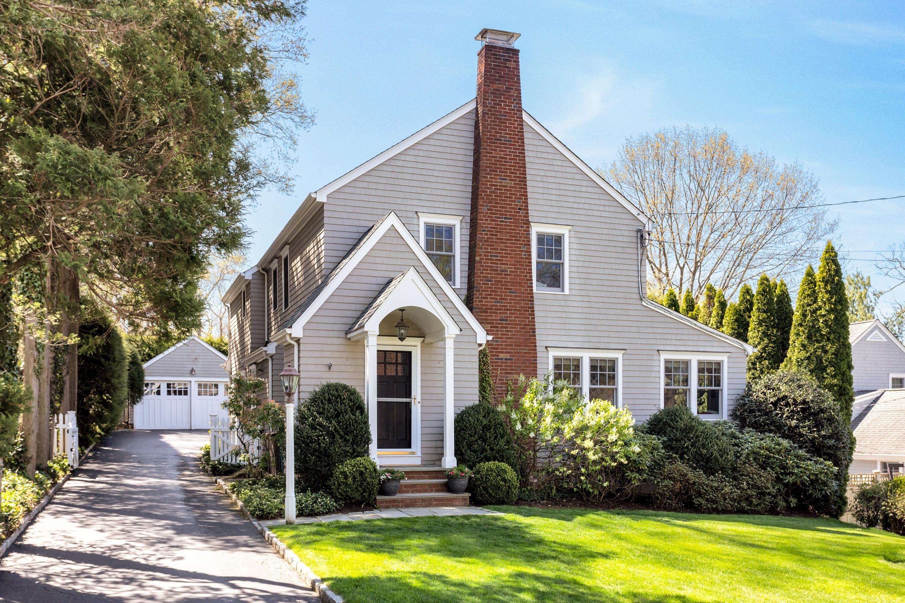 28 Devon Road Darien, CT 06820 - Photo 2 of 40 a front view of a house with a yard