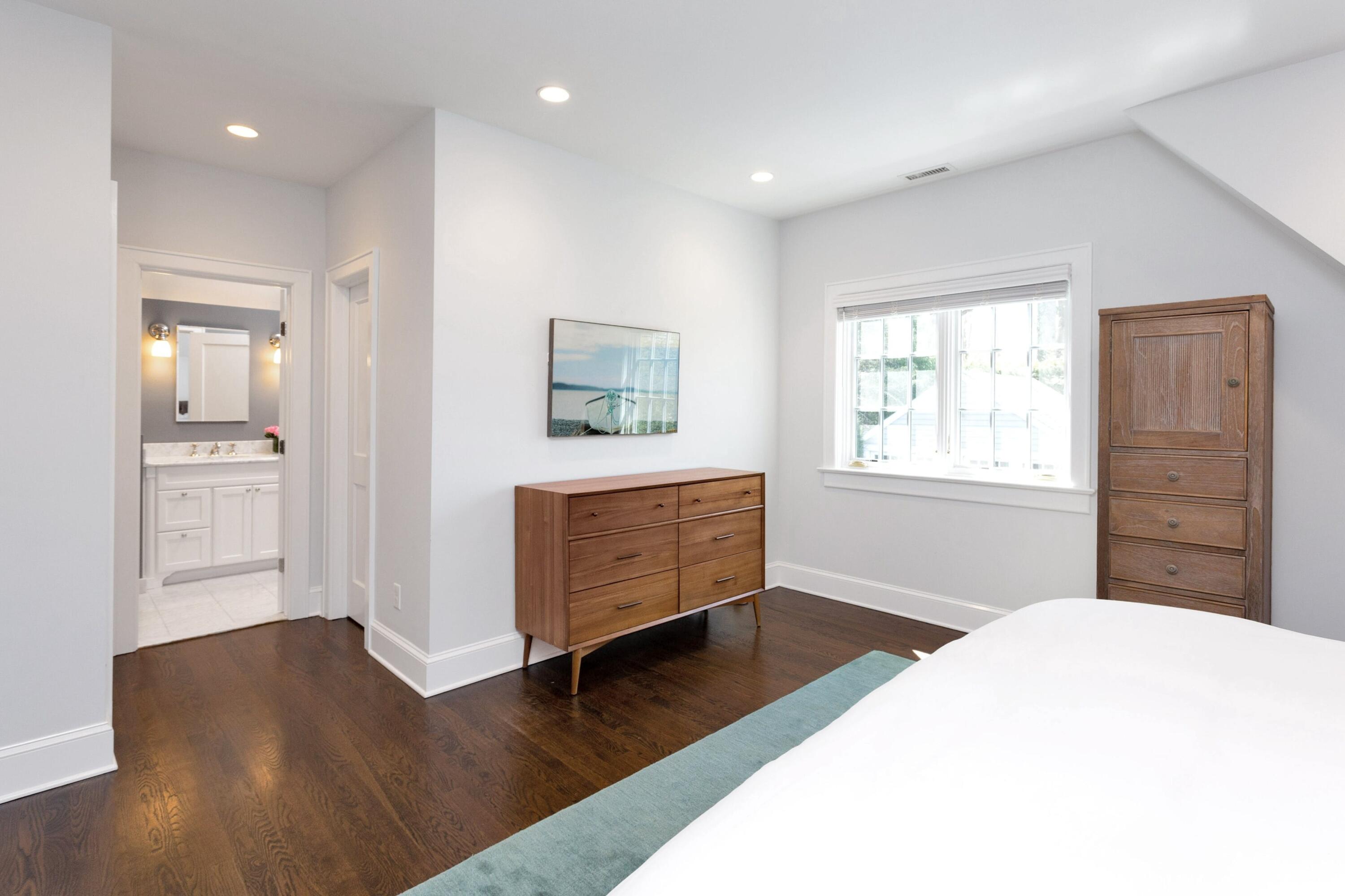 28 Devon Road Darien, CT 06820 - Photo 23 of 40 a bedroom with a bed and wooden floor