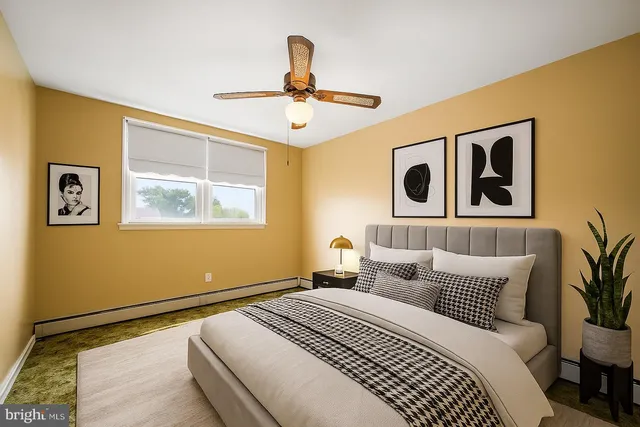 a spacious bedroom with a bed a couch and a window