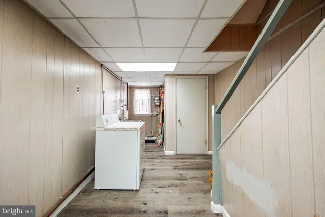 a living room with furniture a rug and a window