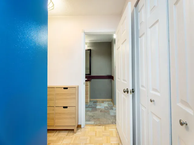 a bedroom with a bed furniture a book shelf and a book shelf
