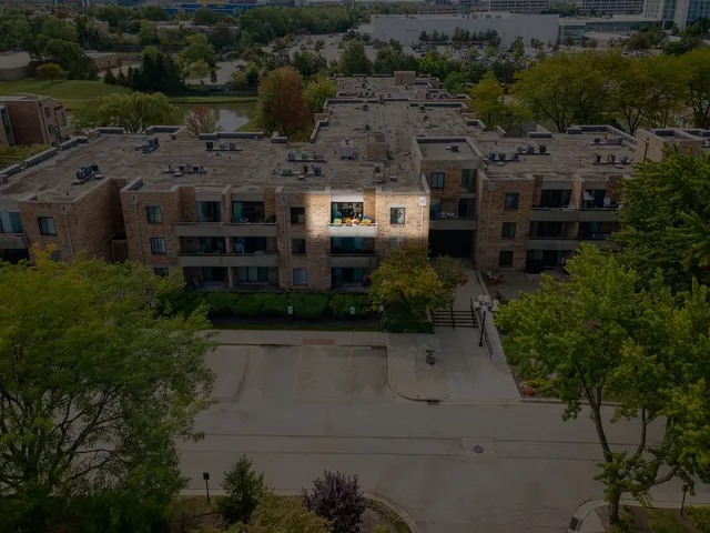 an aerial view of a house with a pool yard and outdoor seating