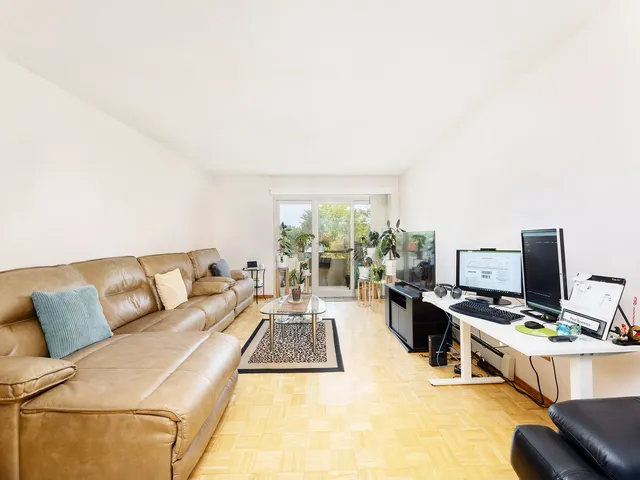 a living room with furniture and a flat screen tv