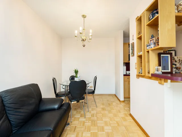 a kitchen filled with lots of clutter and cabinets