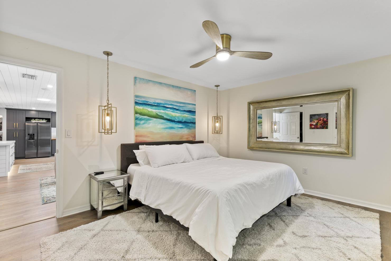 149 Big Springs Drive Naples, FL 34113 - Photo 13 of 35 a bedroom with a large bed and a chandelier