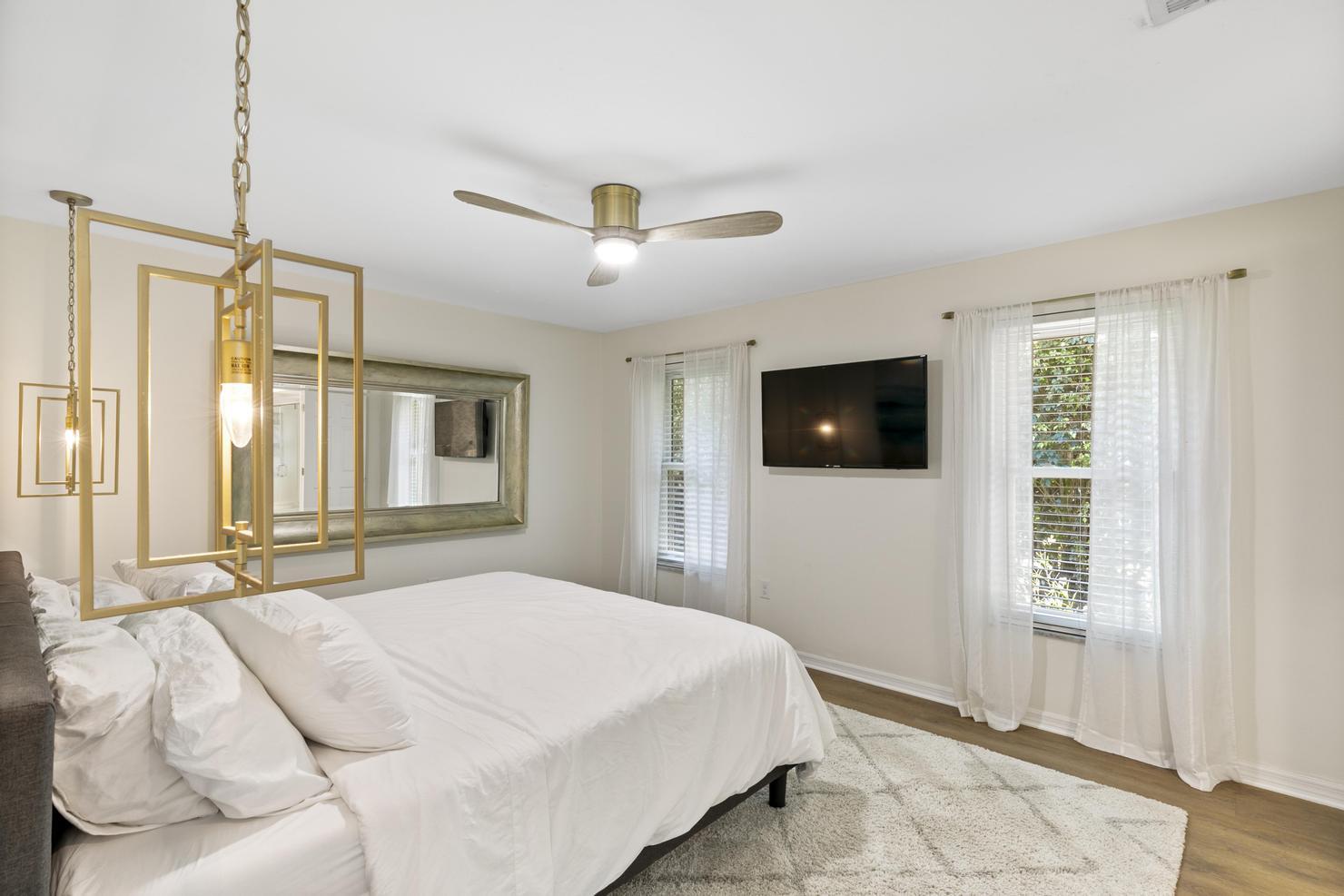 149 Big Springs Drive Naples, FL 34113 - Photo 14 of 35 a bedroom with a bed and a flat screen tv