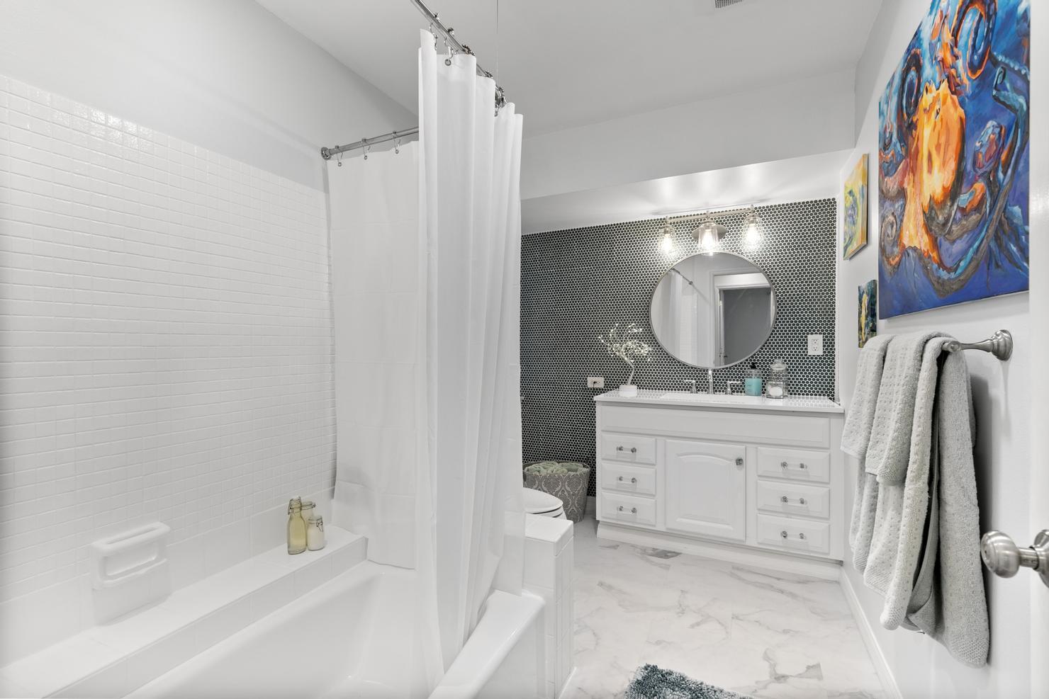 149 Big Springs Drive Naples, FL 34113 - Photo 18 of 35 a spacious bathroom with a granite countertop sink mirror and a bathtub