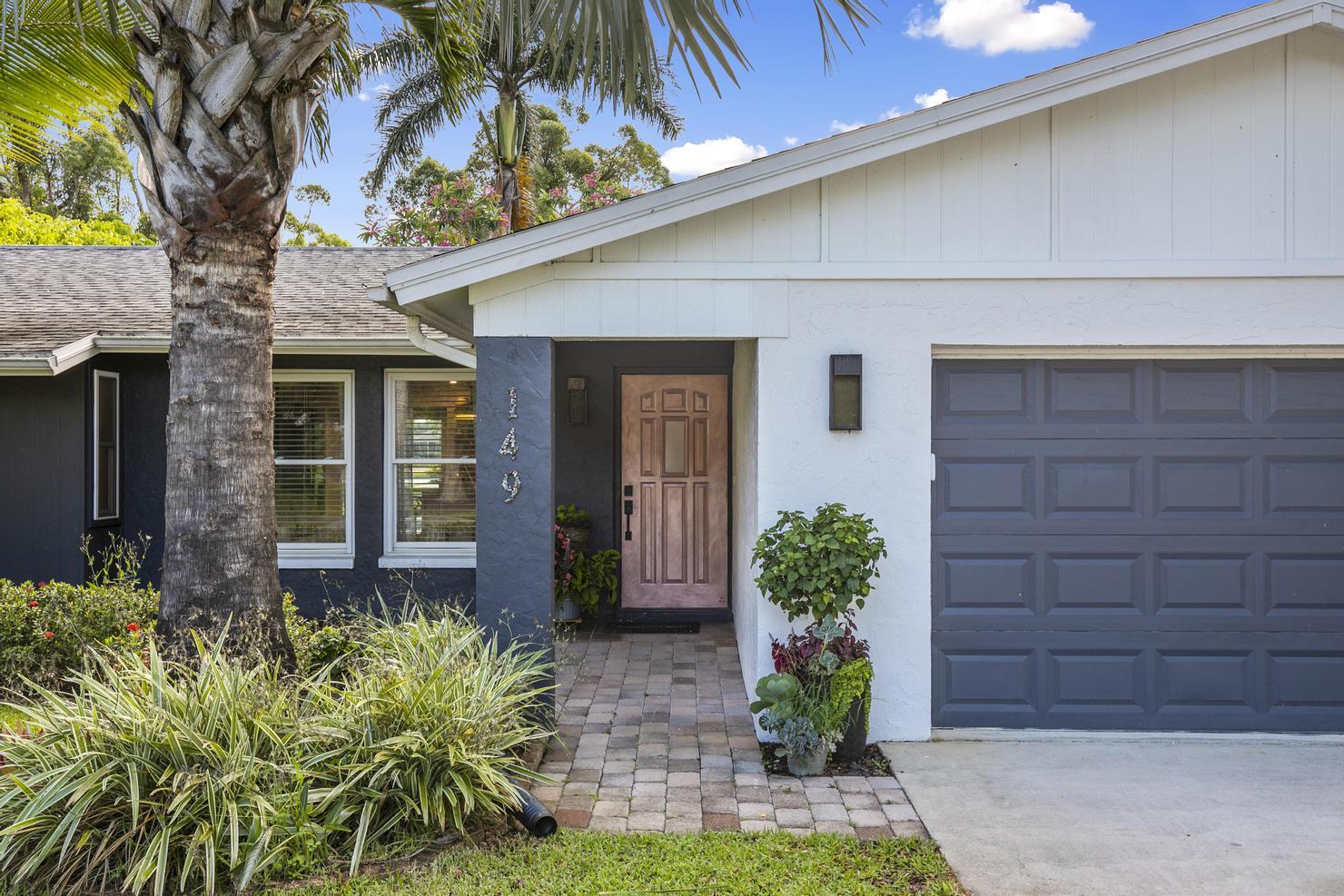 149 Big Springs Drive Naples, FL 34113 - Photo 27 of 35 a front view of a house with garden