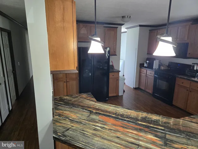 a kitchen with a refrigerator and a stove top oven